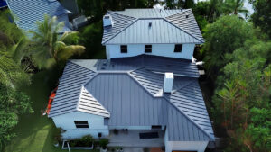 Aerial view of a standing seam metal roof highlighting flat roofing, insulation, gutters, soffit, and fascia services.