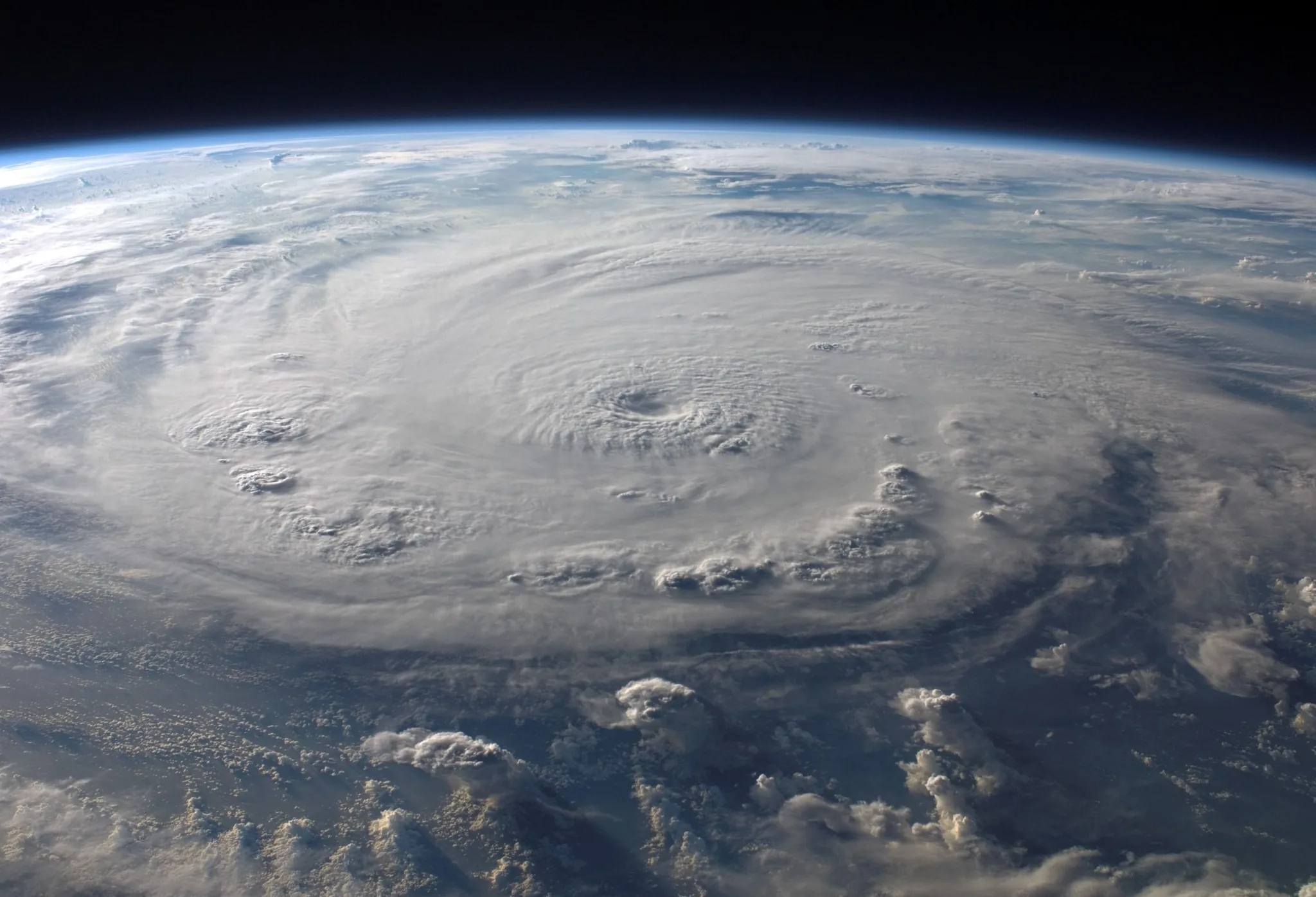 Hurricane with a clearly defined eye viewed from space over the ocean
